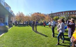 Panoramic view of the attendees on the lawn outside the Hintz Alumni Center.