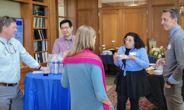 SSRI cofunded faculty members mingling and chatting.