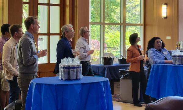Group shot of SSRI cofunded faculty members listening to Deb Ehrenthal, SSRI Director present.