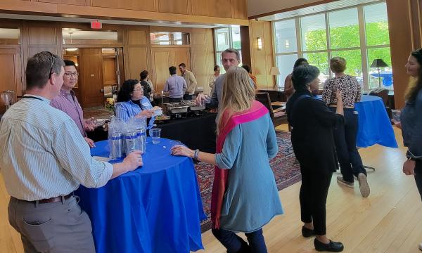 SSRI cofunded faculty members mingling and chatting.