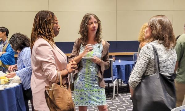 Attendees from the IFSE Workshop enjoy a reception.