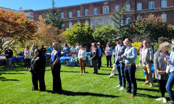 Panoramic view of the attendees on the lawn outside the Hintz Alumni Center.