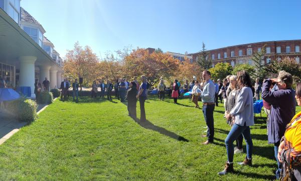 Panoramic view of the attendees on the lawn outside the Hintz Alumni Center.