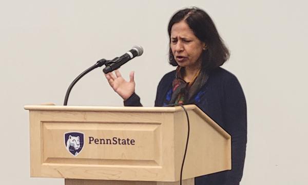 Neeraj Kaushal presents her research to the group.