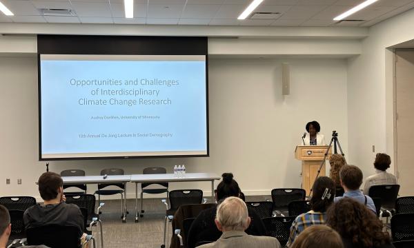 Photo of Audrey Dorélien presenting to De Jong Lecture attendees.