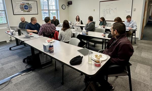 Attendees participate in an SSRI Open House about the Scholar Strategy Network in the SSRI conference room in Henderson Building.