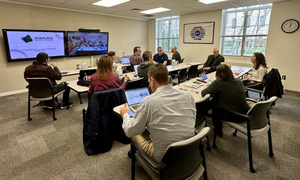 Attendees participate in an SSRI Open House about the Scholar Strategy Network in the SSRI conference room in Henderson Building.