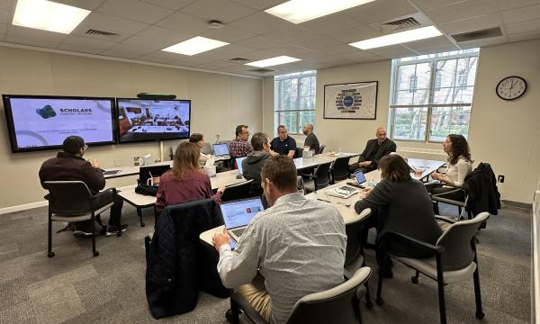 Attendees participate in an SSRI Open House about the Scholar Strategy Network in the SSRI conference room in Henderson Building.