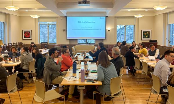 Symposium attendees engage with the various speakers and presentations.
