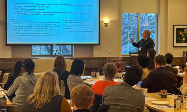 Symposium attendees engage with the various speakers and presentations.