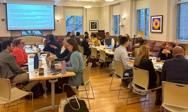 Symposium attendees engage with the various speakers and presentations.
