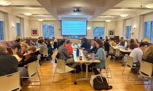 Symposium attendees engage with the various speakers and presentations.