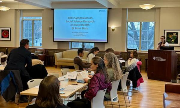 Symposium attendees engage with each other.
