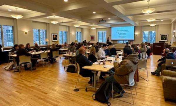 Symposium attendees engage with each other.