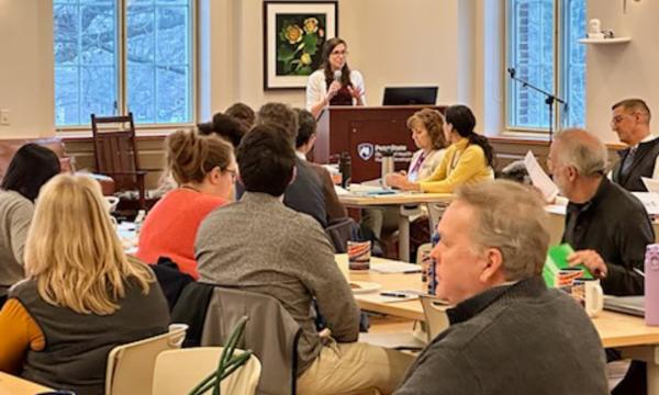Symposium attendees engage with each other.