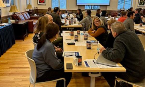 Symposium attendees engage with each other.