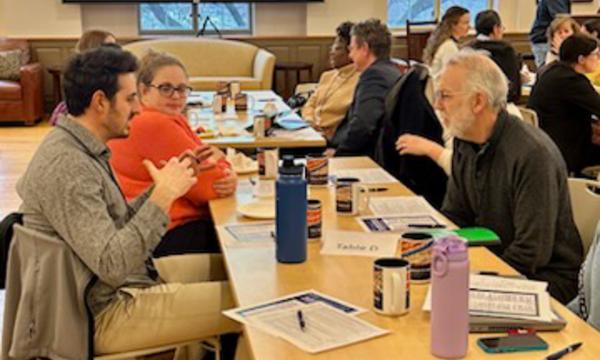 Symposium attendees engage with each other.