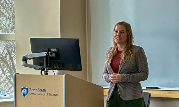 Erika Crable, a white woman with long, blonde hair presents to the group.
