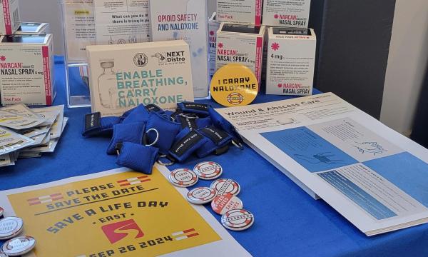 Materials from Penn State's Addiction Center for Translation laid out on a table.