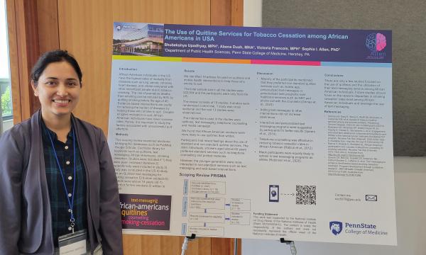 Shubekshya Upadhyay stands next to her poster.