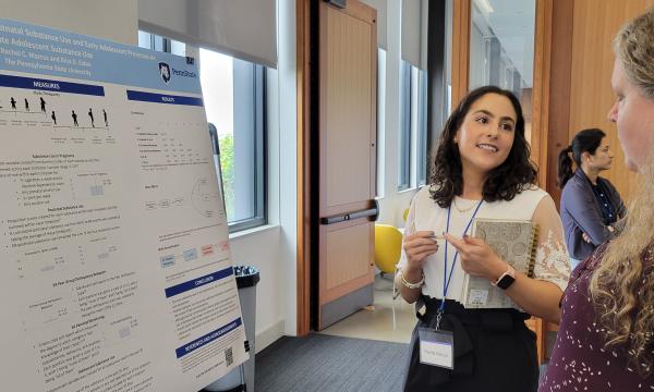 Rachel Marcus explains her poster to Louisa Holmes.