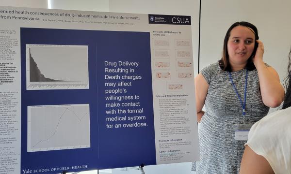 Kim Gannon explains her poster to another student.