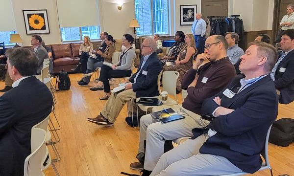 Attendees listen to research flash talks.