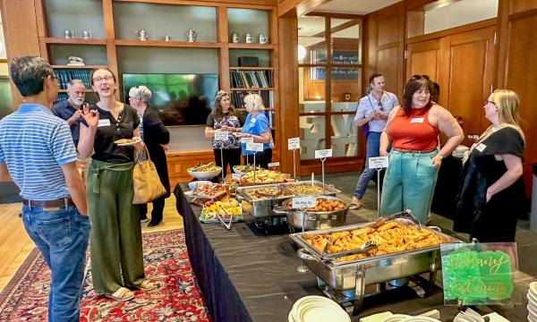 Attendees of the SSRI Spring Celebration event congregate in the Hintz Alumni Hall.
