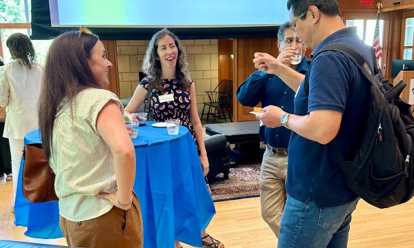 Attendees of the SSRI Spring Celebration event congregate in the Hintz Alumni Hall.