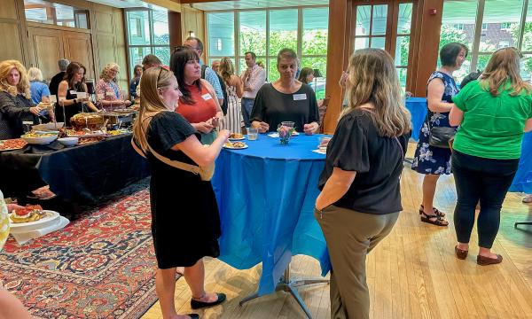 Attendees of the SSRI Spring Celebration event congregate in the Hintz Alumni Hall.