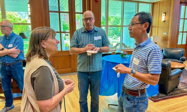 Attendees of the SSRI Spring Celebration event congregate in the Hintz Alumni Hall.