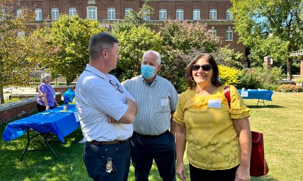 Faculty members mingling at the event.