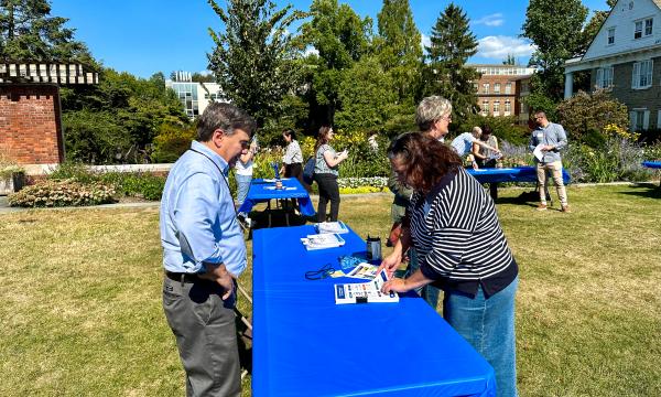 Attendees mingling outside on the Alumni Hall lawn.