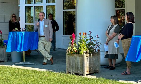 Attendees mingling outside on the Alumni Hall lawn.