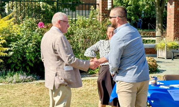Attendees mingling at on the Alumni Hall lawn.