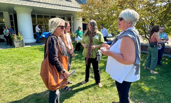 Attendees mingling at on the Alumni Hall lawn.
