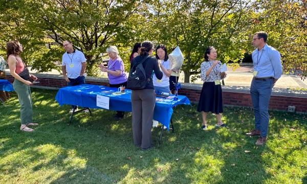 Attendees mingling at on the Alumni Hall lawn.