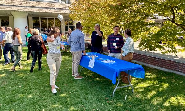 Attendees mingling at on the Alumni Hall lawn.