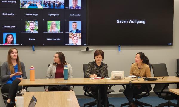 Four women, Jessica Thompson, Kathyrn Risher, Corina Graif, and Thoa Khuu, sit at a table to discuss NIH K awards.