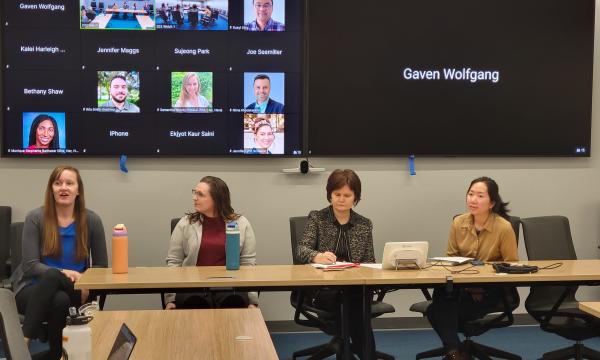 Four women, Jessica Thompson, Kathyrn Risher, Corina Graif, and Thoa Khuu, sit at a table to discuss NIH K awards.