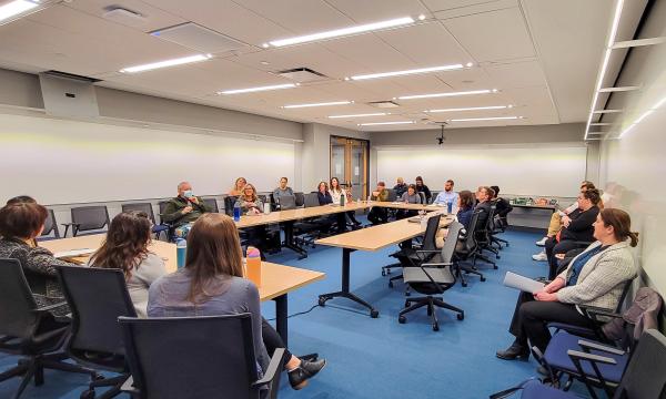 Open House attendees listen to the presentation about NIH K grants.