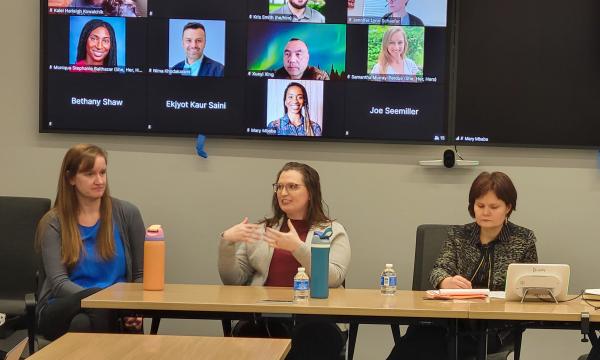 Four women, Jessica Thompson, Kathyrn Risher, Corina Graif, and Thoa Khuu, sit at a table to discuss NIH K awards.