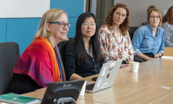 PRI Associates engage in a discussion.