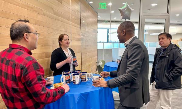 SSRI Open House attendees chatting around a high-top table.