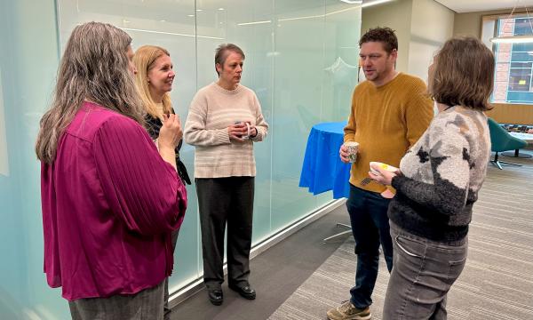 SSRI employees chatting with attendees.