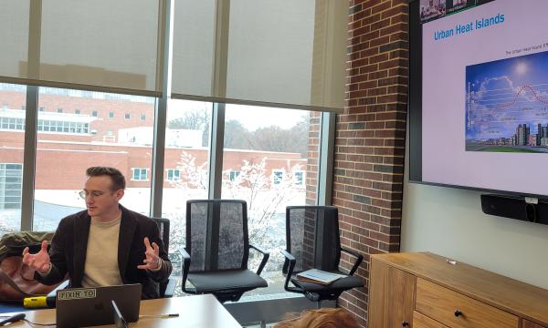 Kyle Aun, SSRI cofunded faculty member, presents to the group.