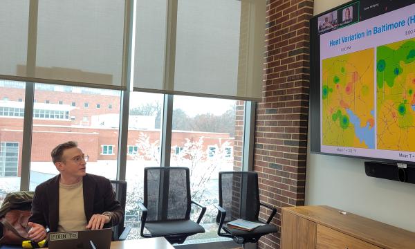 Kyle Aun, SSRI cofunded faculty member, presents to the group.