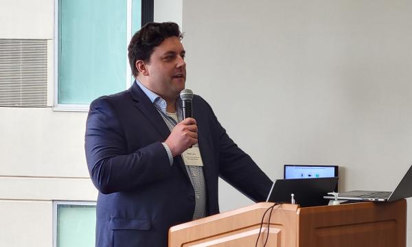 Brad Linn, Assistant Professor of Family and Community Medicine, Molecular and Precision Medicine, and Psychiatry and Behavioral Health, presents to the group.