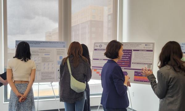 Presenters from the Poster Session show off their posters.
