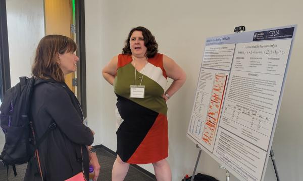 Presenters from the Poster Session show off their posters.